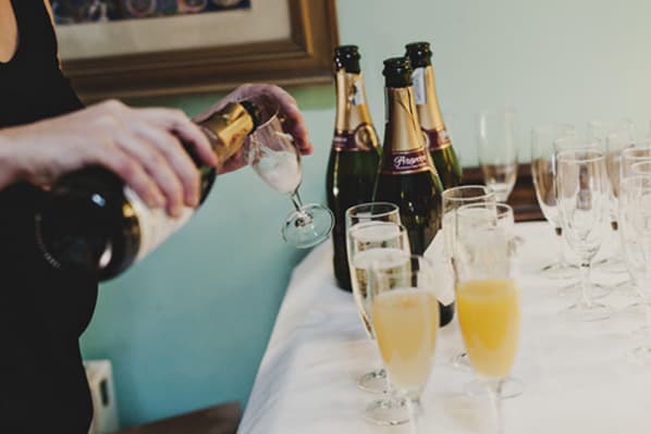 Champagne being poured in the dining room at Temple House