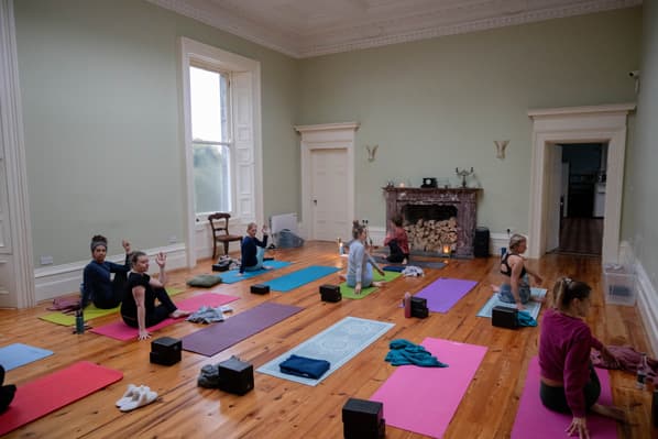 Yoga retreat session in the activity room at Temple House