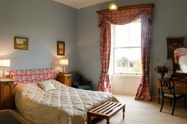 Elegant bedroom at Temple House overlooking the estate parkland