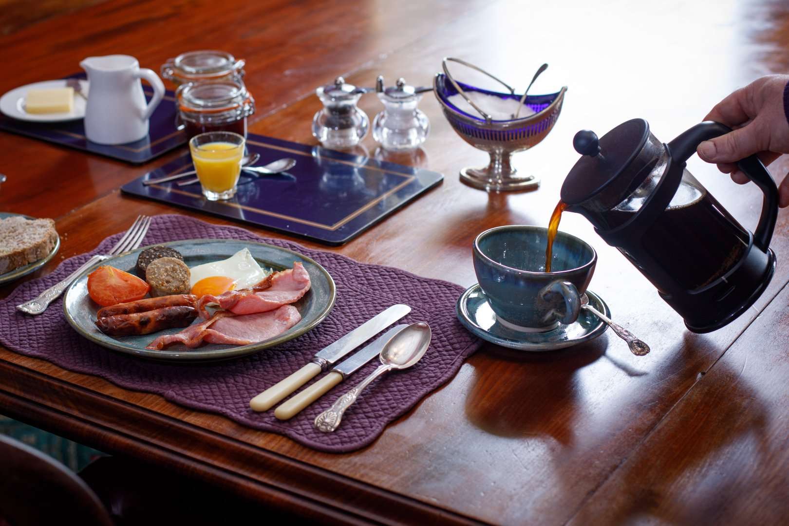 A family sharing platters in the dining room at Temple House