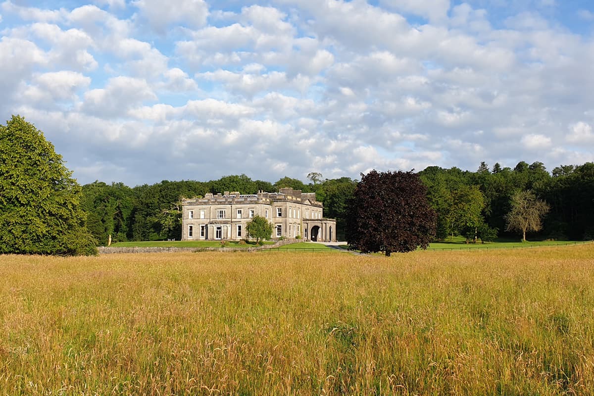Temple House seen through tall grass — a private country estate in the heart of Sligo