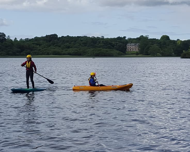 Stand-up paddleboarding on the lake at Temple House, County Sligo — calm water and castle views