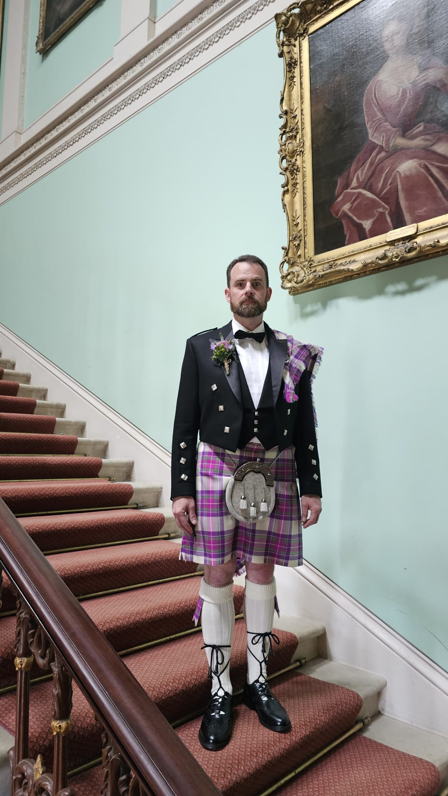 Groom in a kilt on the Temple House staircase