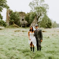 Wedding couple in wellington boots in front of the castle at Temple House