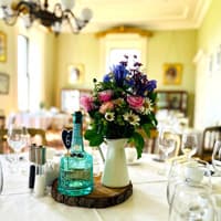 Centrepiece wedding flowers on a table at Temple House