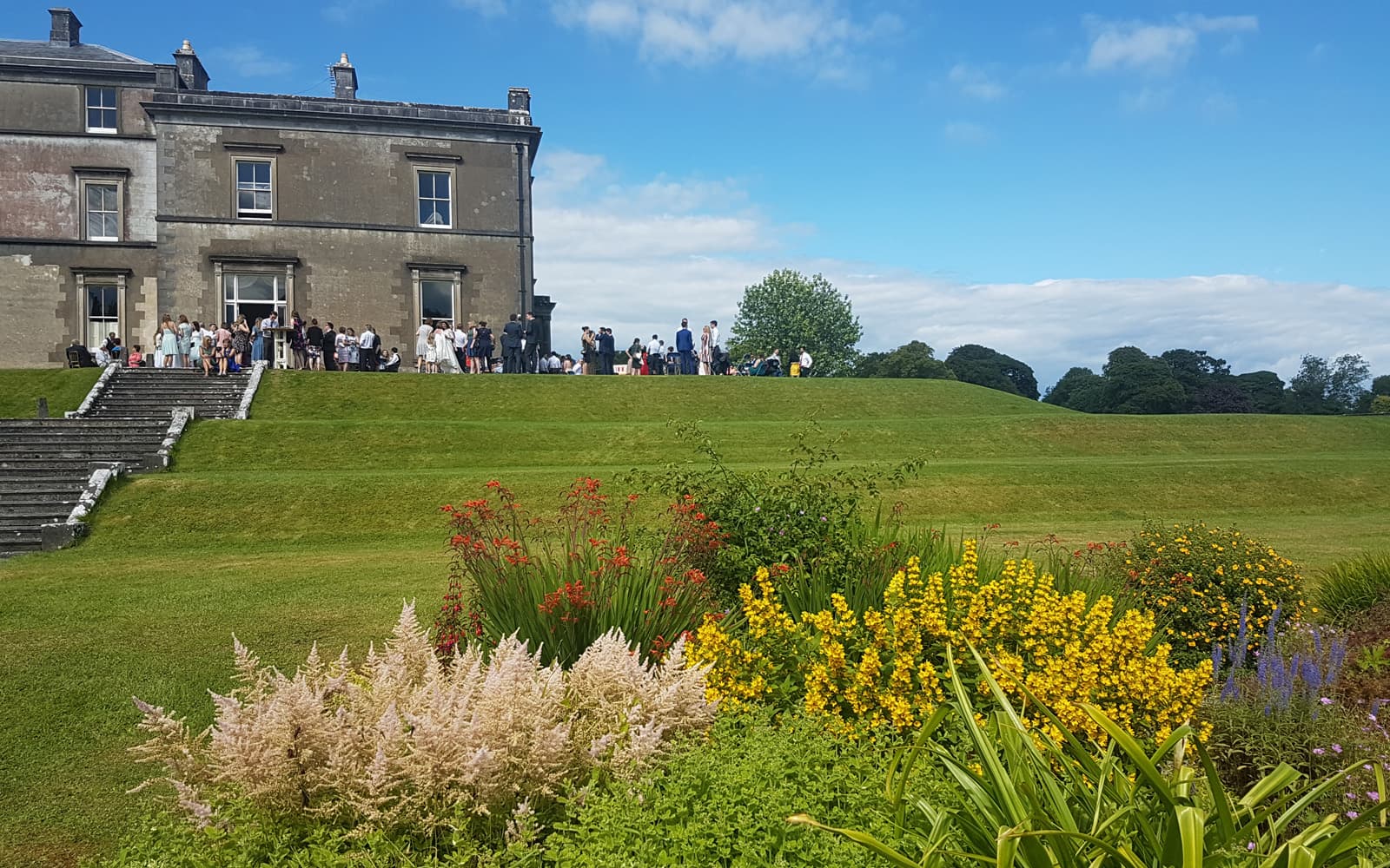 Wedding guests front steps at Temple House